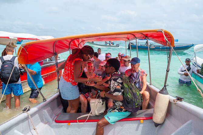 Full Day Tour to 4 Rosario Islands with snorkeling and plankton in Cartagena - Isla Cholon brings music, seafood, and crowds