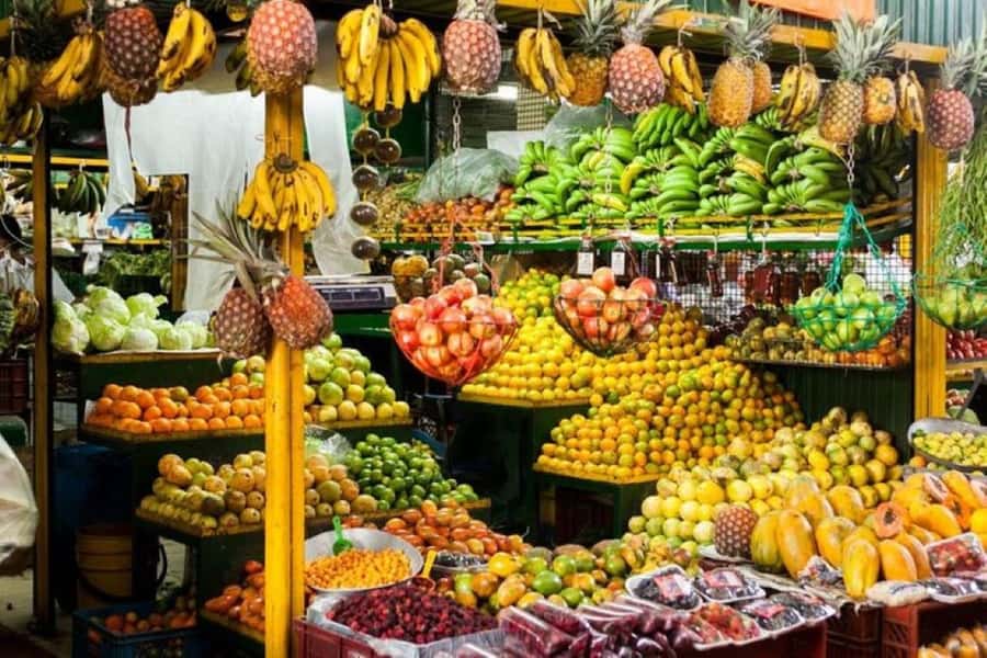 Medellín: Comuna 13 and Exotic Fruits Day Tour - Riding the cable car above Medellín